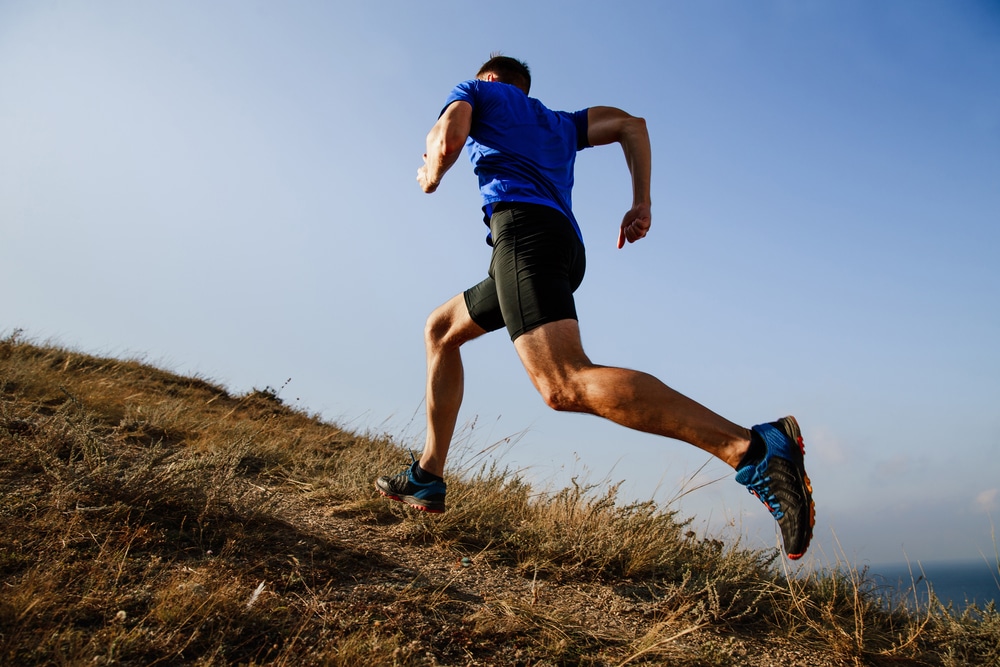 Dynamic,Running,Uphill,On,Trail,Male,Athlete,Runner,Side,View Running ahlete after vein treatment in Aurora , IL