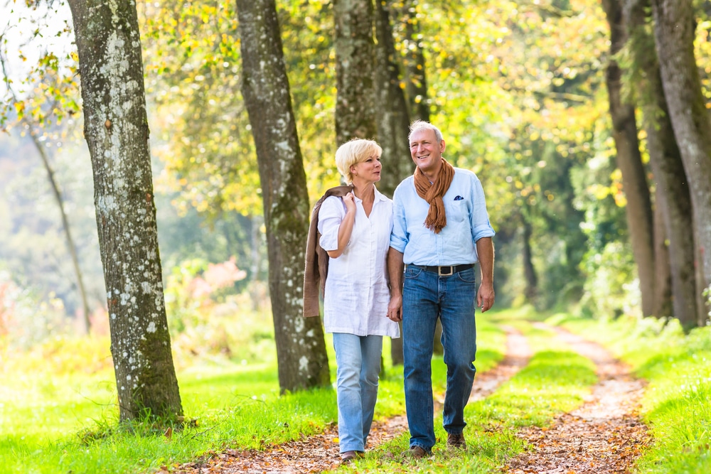 Seniors walking in nature to maintain good circulation.
